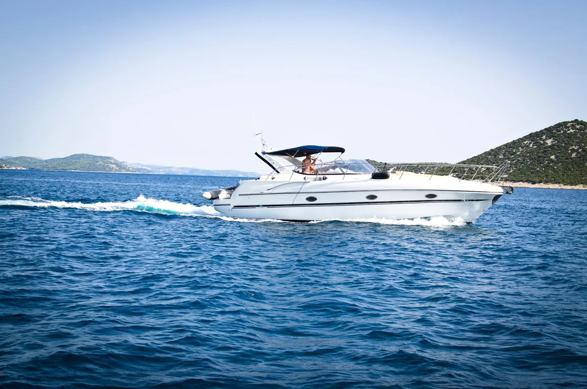 White cabin cruiser with sun canopy