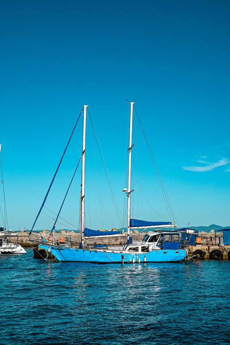 Blue-hull two-mast cruising sailboat