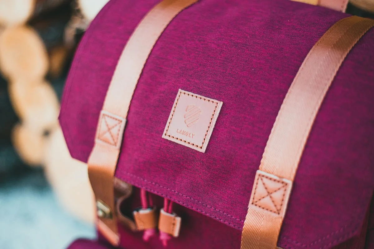 Burgundy backpack with tan straps